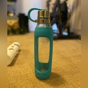 Glass water bottle with blue rubber